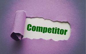 competitor analysis questions written behind torn off paper